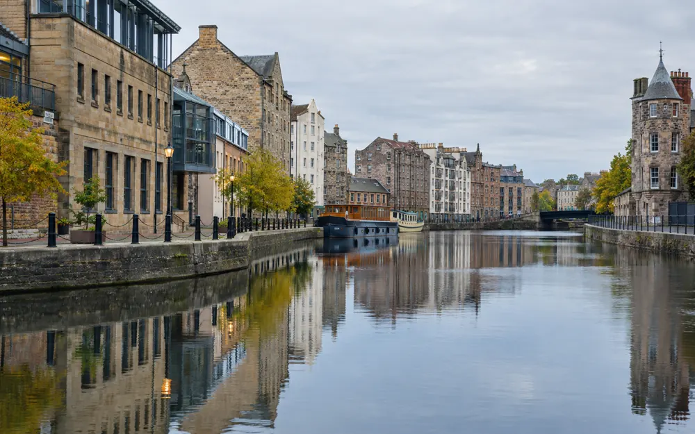 Sandstone buildings and converted commercial warehouses beside the water in Leith